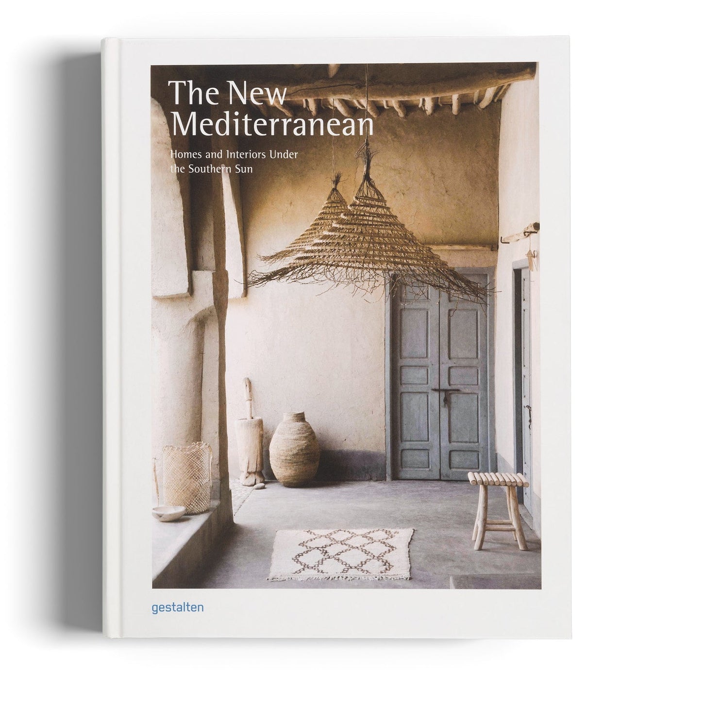 Book titled 'The New Mediterranean' with a cover featuring interior design images on a white background